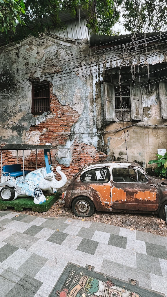 New rusty vintage car with a tuktuk The new elephant tuktuk behind the rusty vintage car