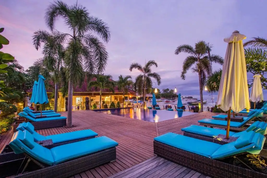 Bay Shore hut pool with all lounges blue around - the setting is at sunset with the best sky colours possible