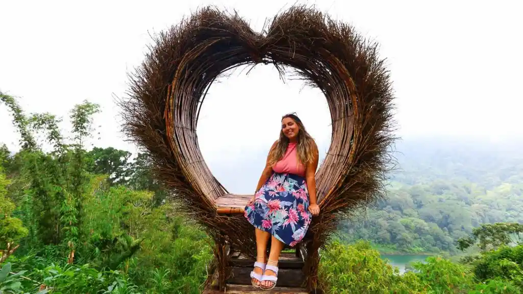 Twin Lakes Bali Instagram spots heart shape Ale sitting in a heart shaped photospot in Bali twin lake viewpoint