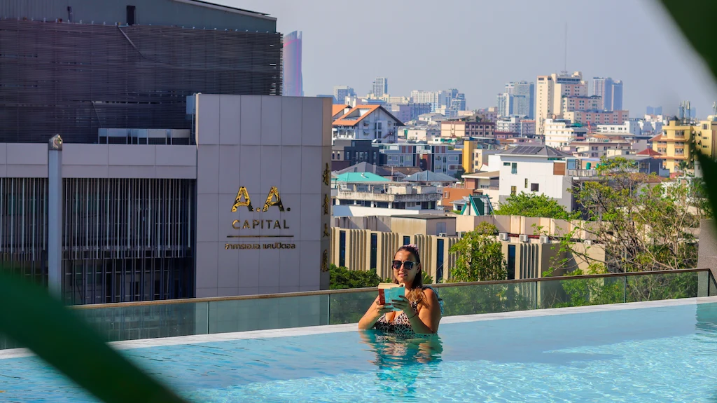Enjoying the infinity pool and reading a book at Somerset Rama 9 Bangkok