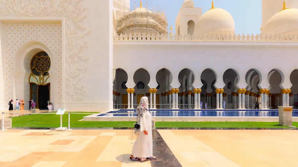 Walking through the gardens of Abu Dhabi White Mosque admiring the architecture and the white colour
