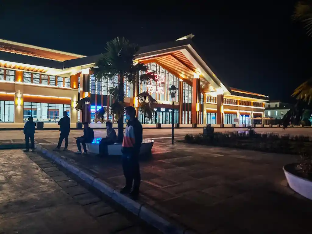 You will find local buses outside the train stations to the town centre for just 15K Kips