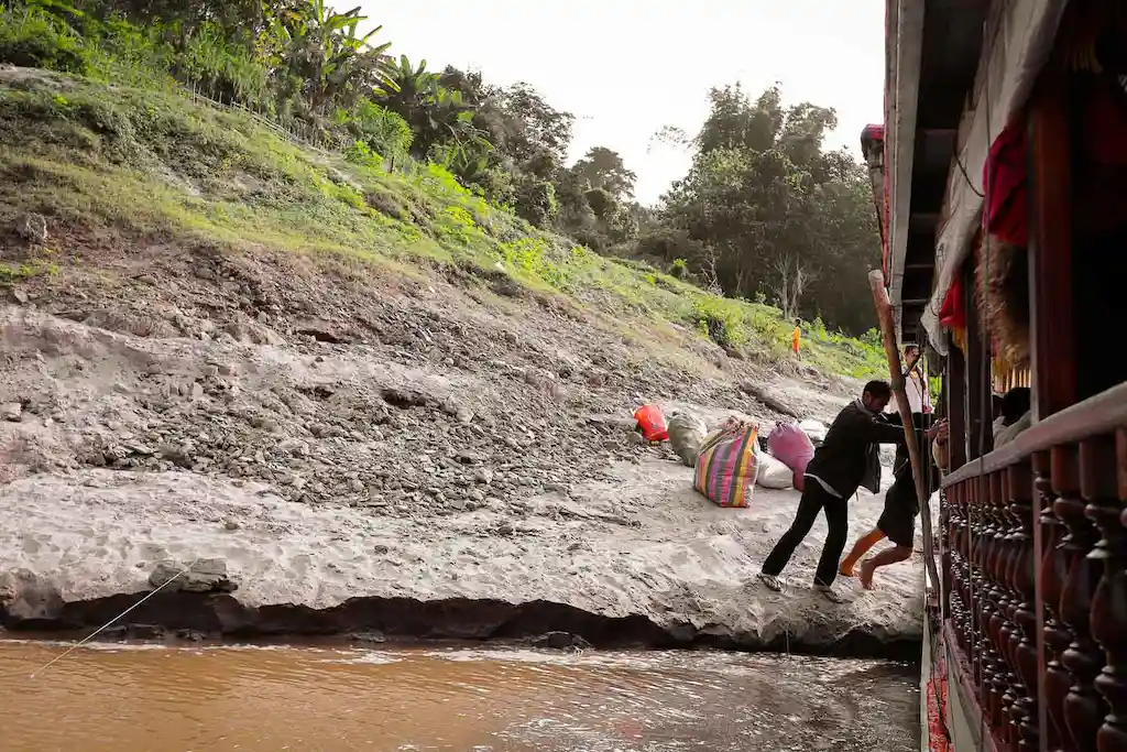 Locals pushing the boat after a quick stop