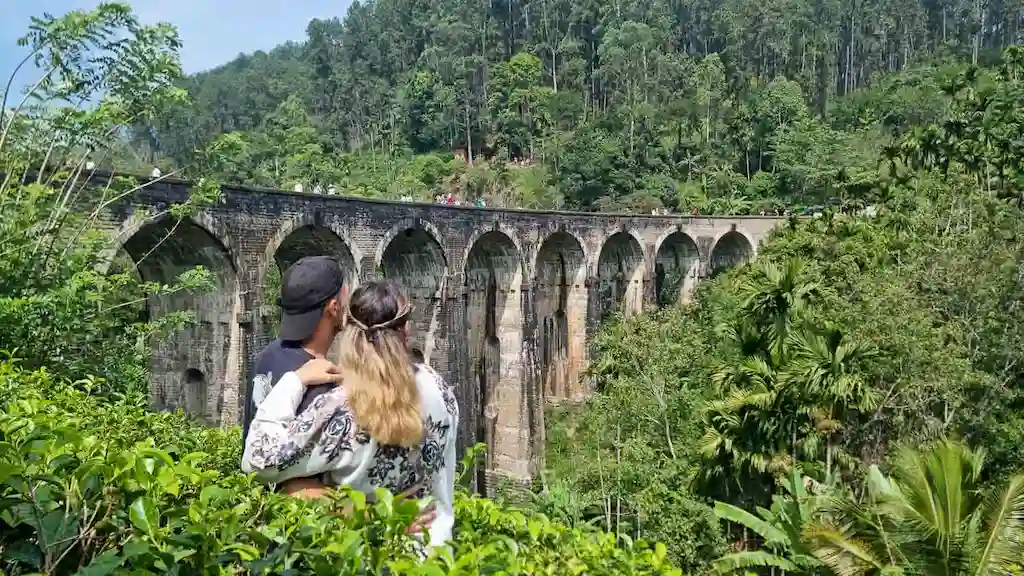 Toti and Ale hugging and enjoying the view of Nine Arch Bridge | Passport and Stamps