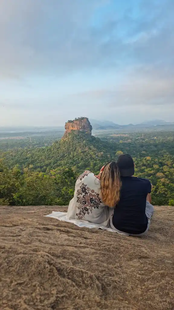 Enjoying the sunrise on Pudurangala Rock with the view of Sigiryia