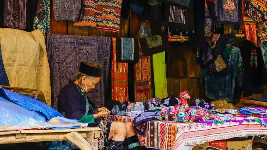A snap of an old lady dressed as traditional H'mong in Sapa cat cat village at a souvenir shop