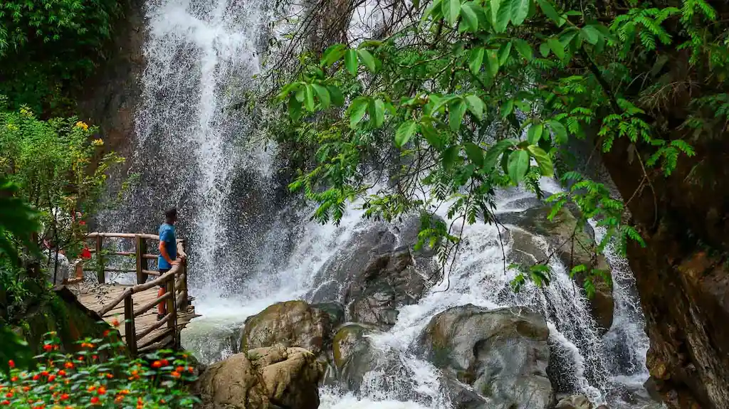 Admiring the stunning waterfall in Cat Cag village Sapa