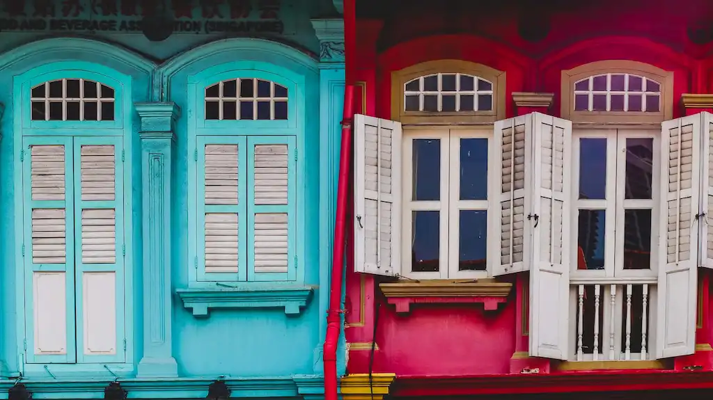 Traditional windows in Chinatown Singapore with vibrant colours and different style British Colonial and Portuguese