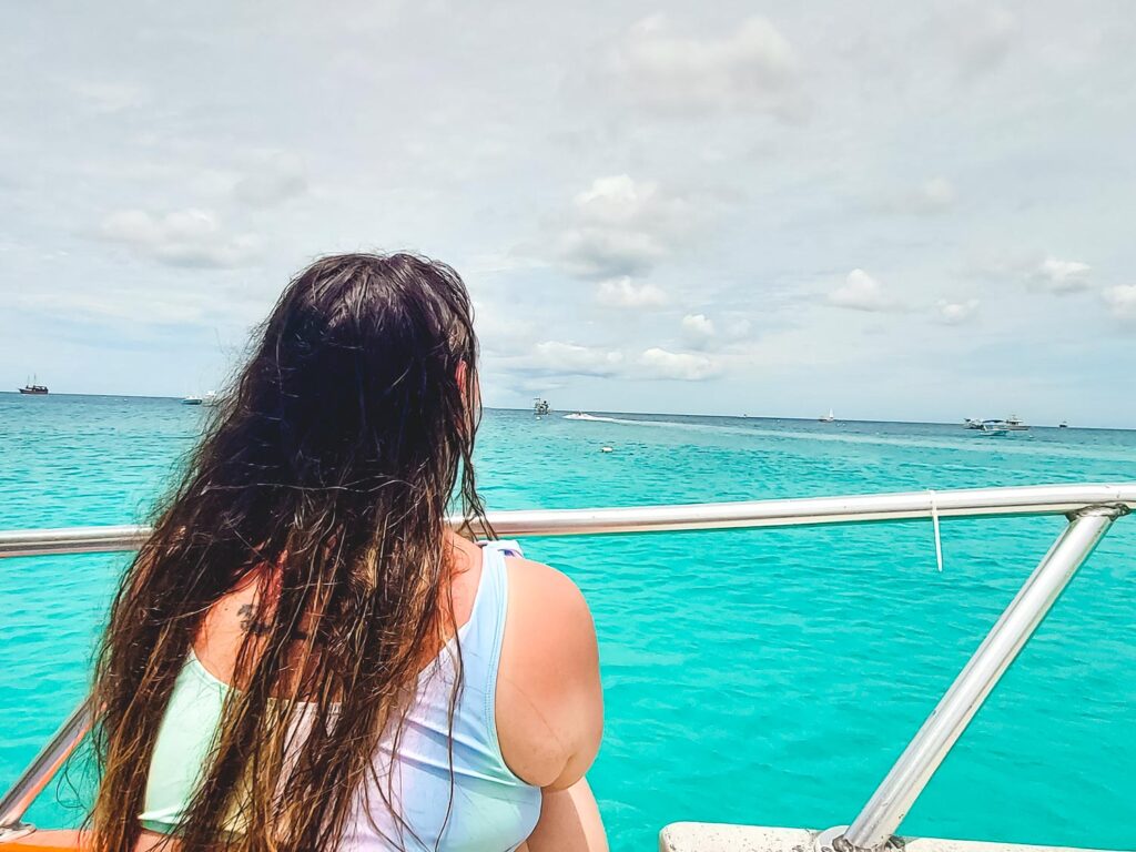 Bimba of Passport and Stamps looking at the beautiful water of the ocean