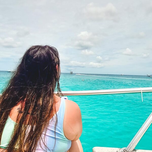 Bimba of Passport and Stamps looking at the beautiful water of the ocean