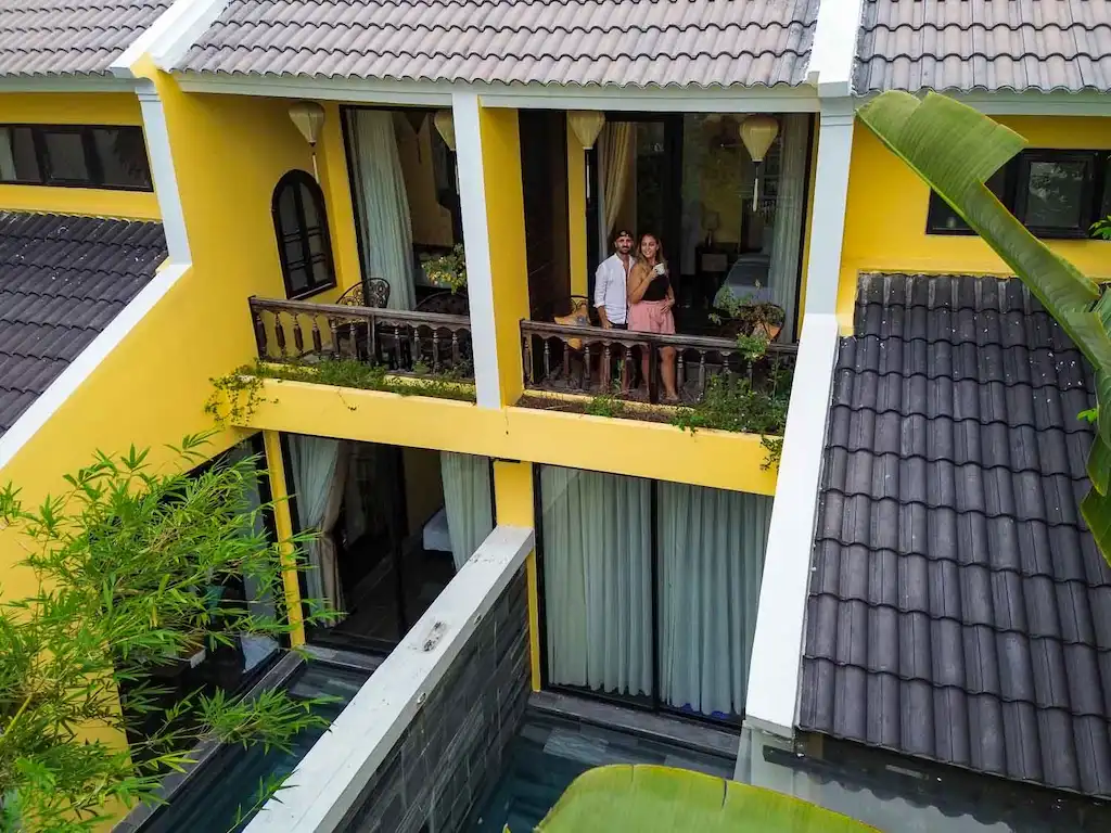 toti and ale of passport and stamps from a cute balcony on the best accommodation to stay in hoi an with private pool