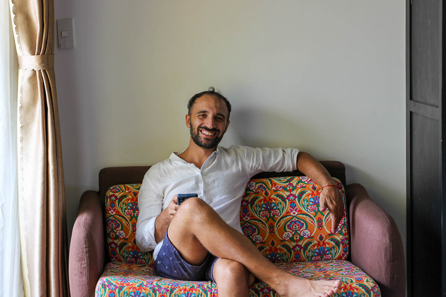 Toti sitting on the sofa of our accommodation in Hoi An - Rosie villa
