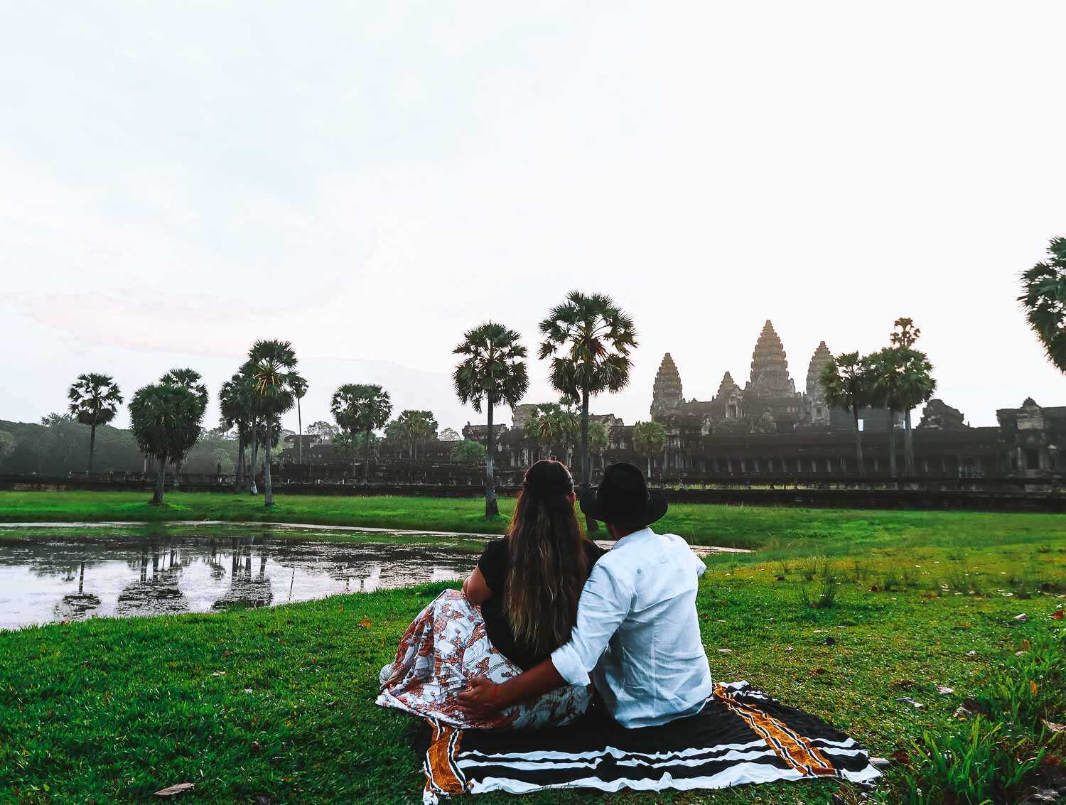 Angkor Watt sunrise by the lake couple shot A couple by the lake watching the sunrise at Angkor Wat Unesco Park