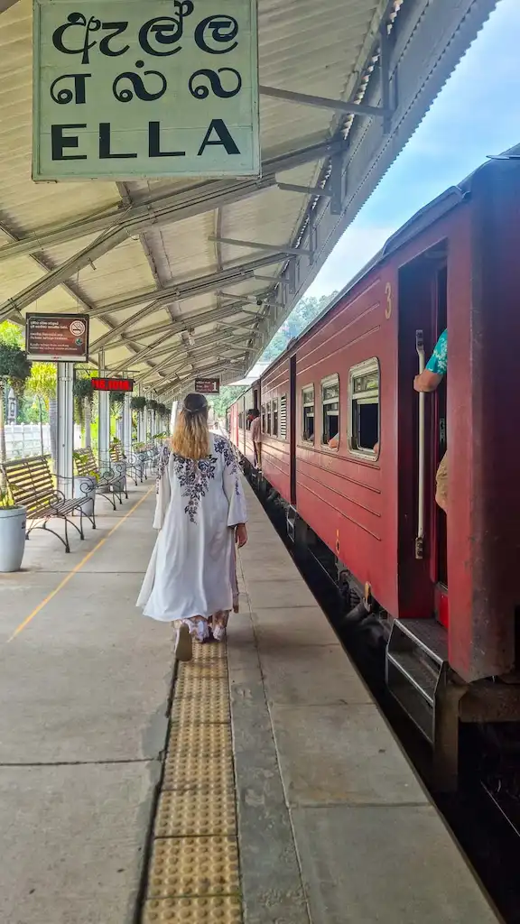 Taking the train in Ella Bimba walking along the platform in Ella train station