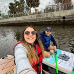 Toti and Ale paddleboarding along the Hillsborough river | Passport and Stamps
