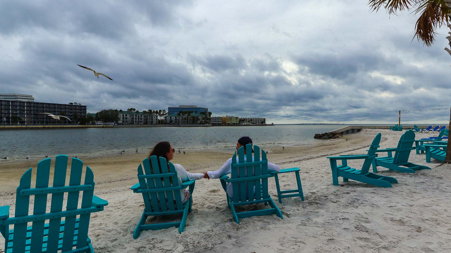 Holding hands on the beach in Florida. Toti and Ale sitting on the beach side of Whiskey Joe's