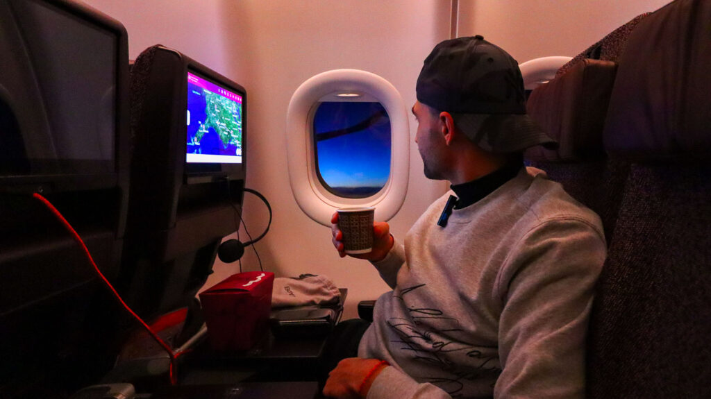 Toti enjoying a drink on board of the plane