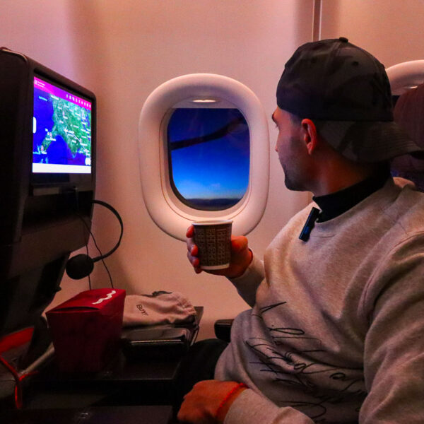 Toti enjoying a drink on board of the plane