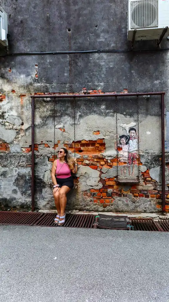 Bimba sitting on a swing with the cutest murals