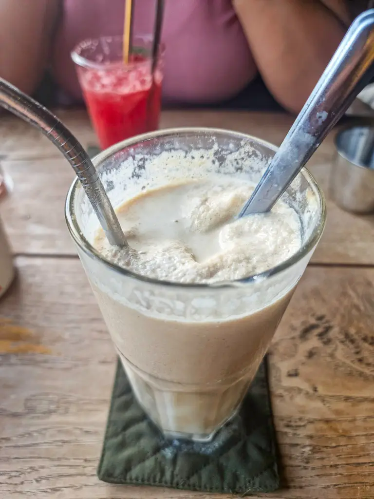 Having a coconut coffee at Cong Cafe in Hanoi