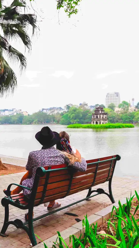 Toti and Ale sitting beside Hoan Kiem Lake in Hanoi, northern Vietnam