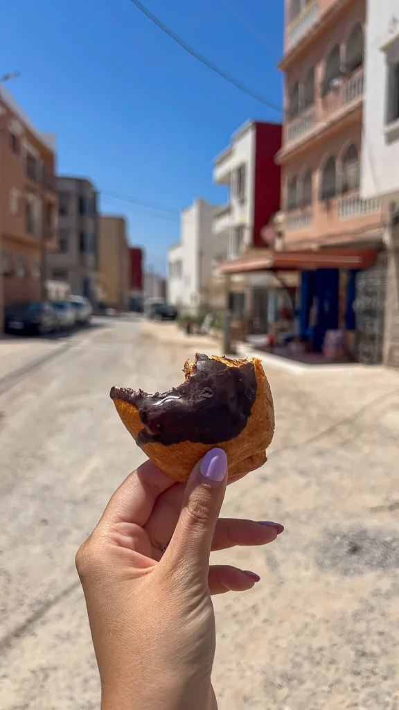 Eating fresh baked pastry from a bakery in the old town of Tamraght