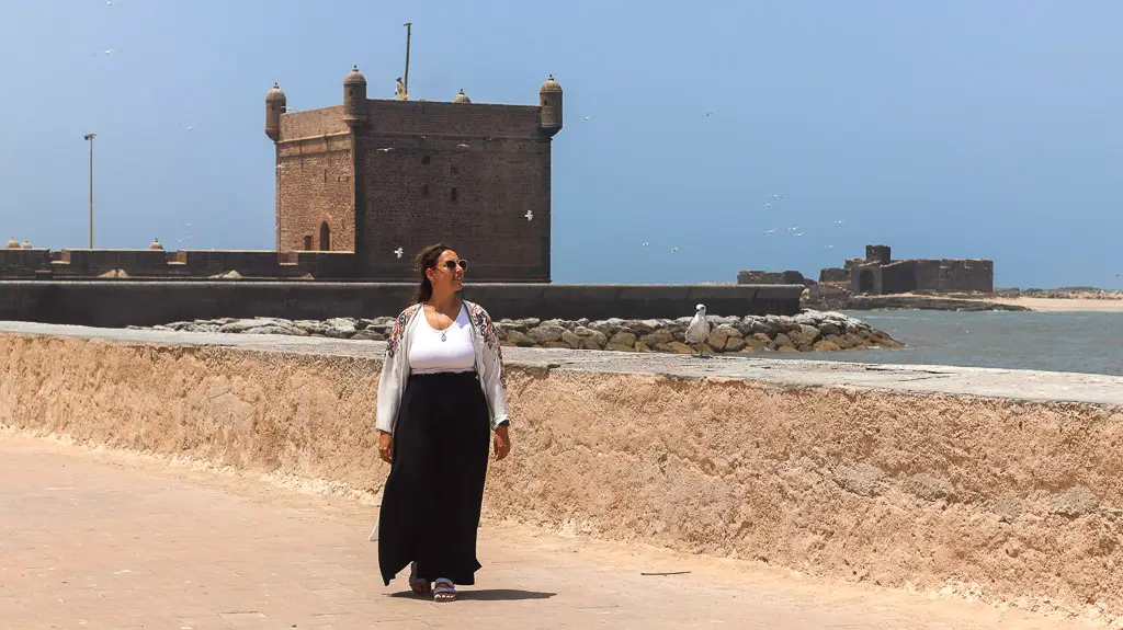 Walking along the promenade with Port of Essaouira Sqala as background Walking along the promenade of Essaouira - Staying always connected with eSim in Morocco