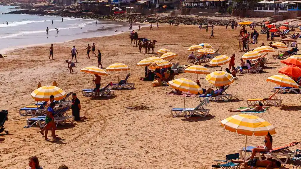 lounges on taghazout beach Taghazout beach - Sunbeds and umbrellas along the beach - Best things to do in Taghazout