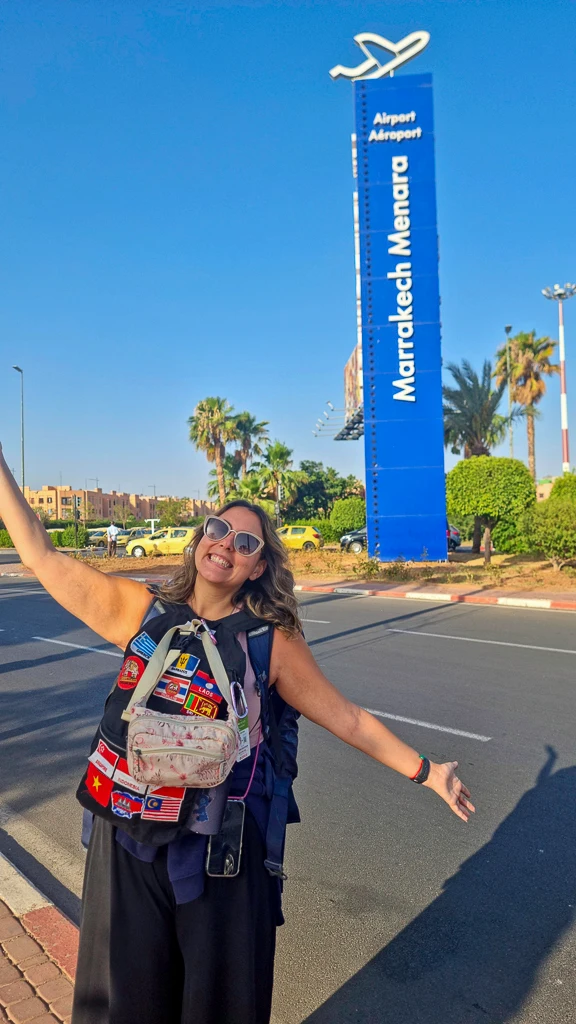 Ale with the sign of Marrakech airport at the back Ale entering the airport in Marrakech