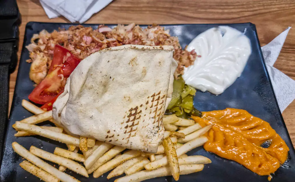 Our date night in Marrakech eating perfectly cooked shawarama - The people working at Iraki Shawarama are so nice offering us free top up sauce.