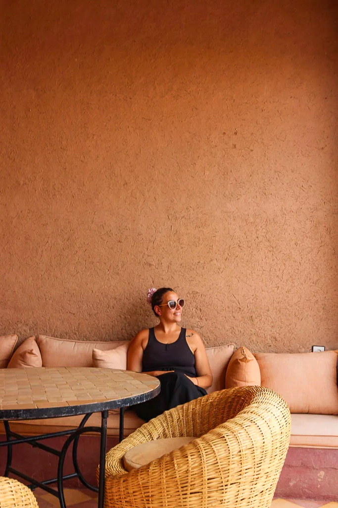 Author Ale relaxing on a traditional clay terrace at a Merzouga desert hotel, showcasing the authentic earthen architecture and sun-drenched atmosphere of a Saharan stay.