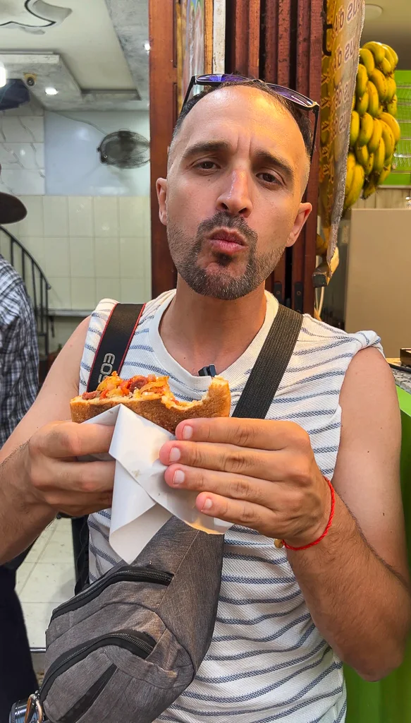 Toti eating a delicious mixxed sandwich in Marrakech