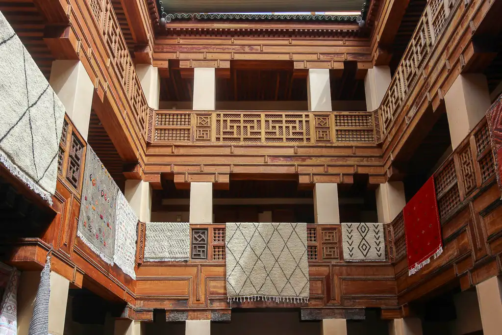 Interior patio of Funduq Staouniyyin Fes with carved railings and intimate scale