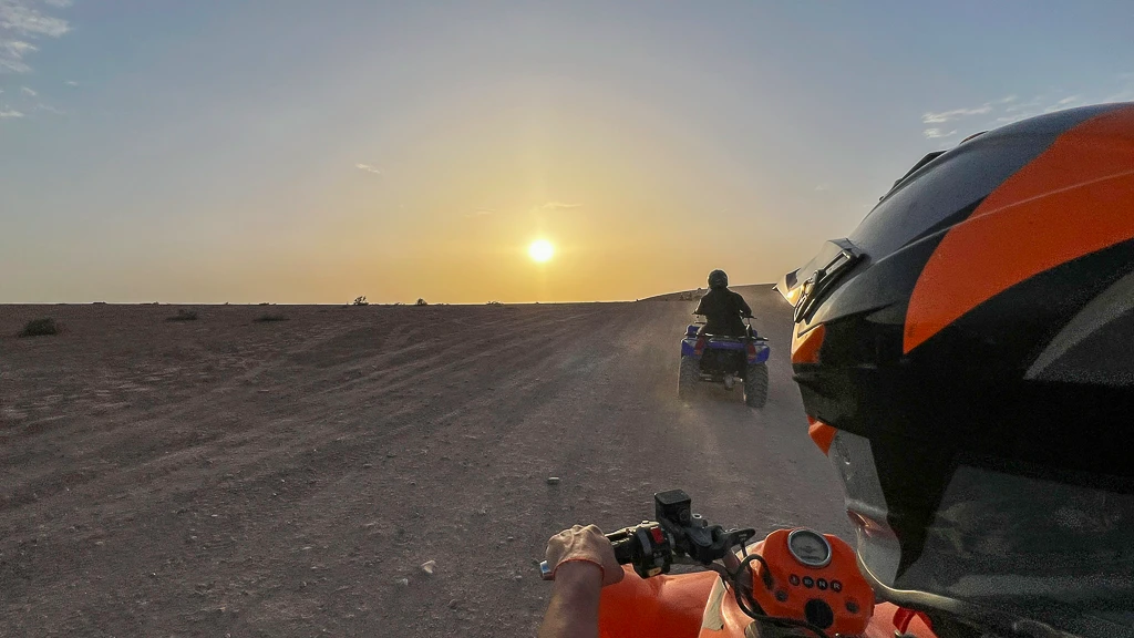 Enjoying the sunset ride on a quod in Agafay desert in Morocco