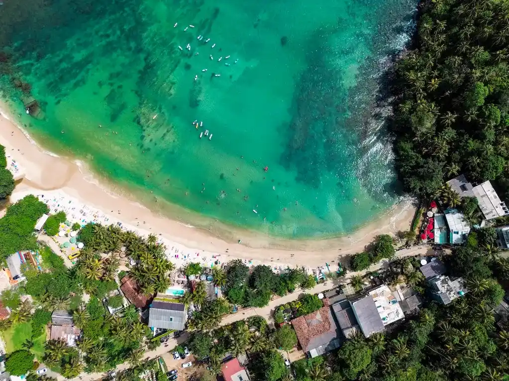 The famous hiriketiya bay with surfers It was crazy beautiful watching the bay for it's entirety flying our drone, as you can clearly understand the raw natural beauty of Hiriketiya bay