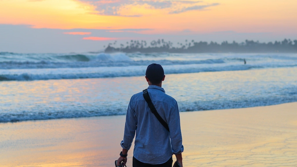 Toti Walking on Dickwella beach at sunset Passport and stamps author Enjoying a gorgeoys sunset in Hiriketiya Sri Lanka