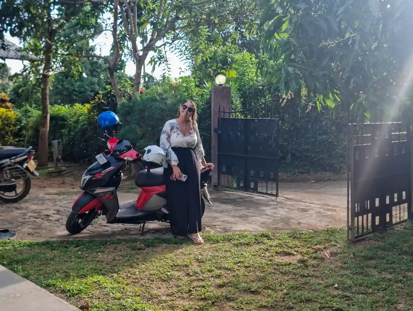 Ale sitting on our fantastic scooter in our guesthouse on the hills of Hiriketiya