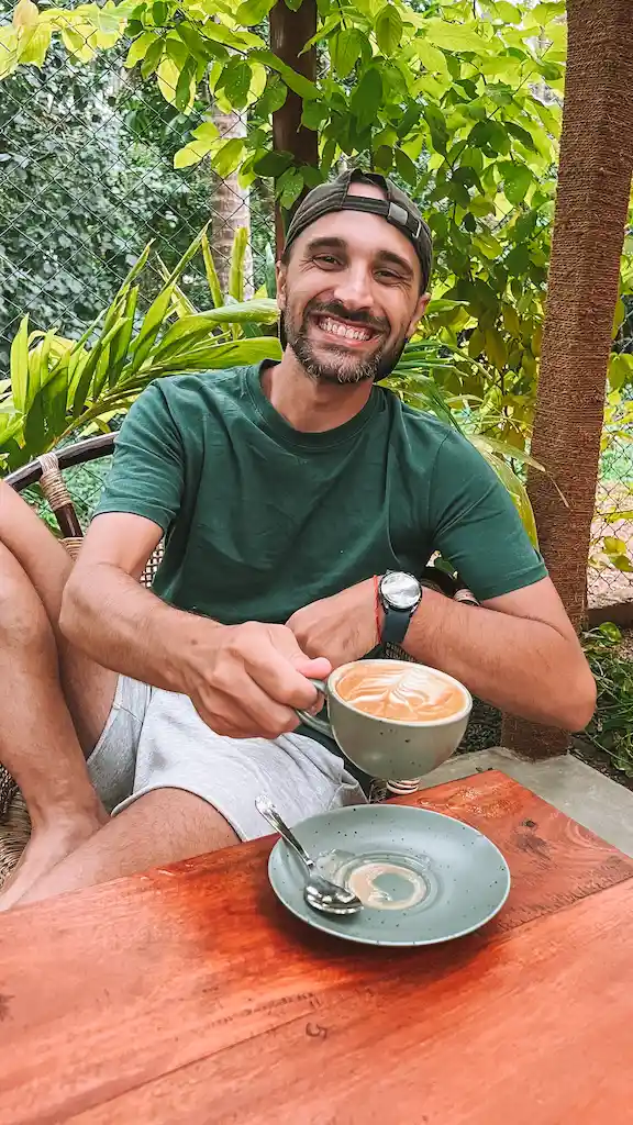 Toti enjoying a coffee at Avocado Toast Toti enjoying a latte from the garden of Avo toast in Hiriketiya