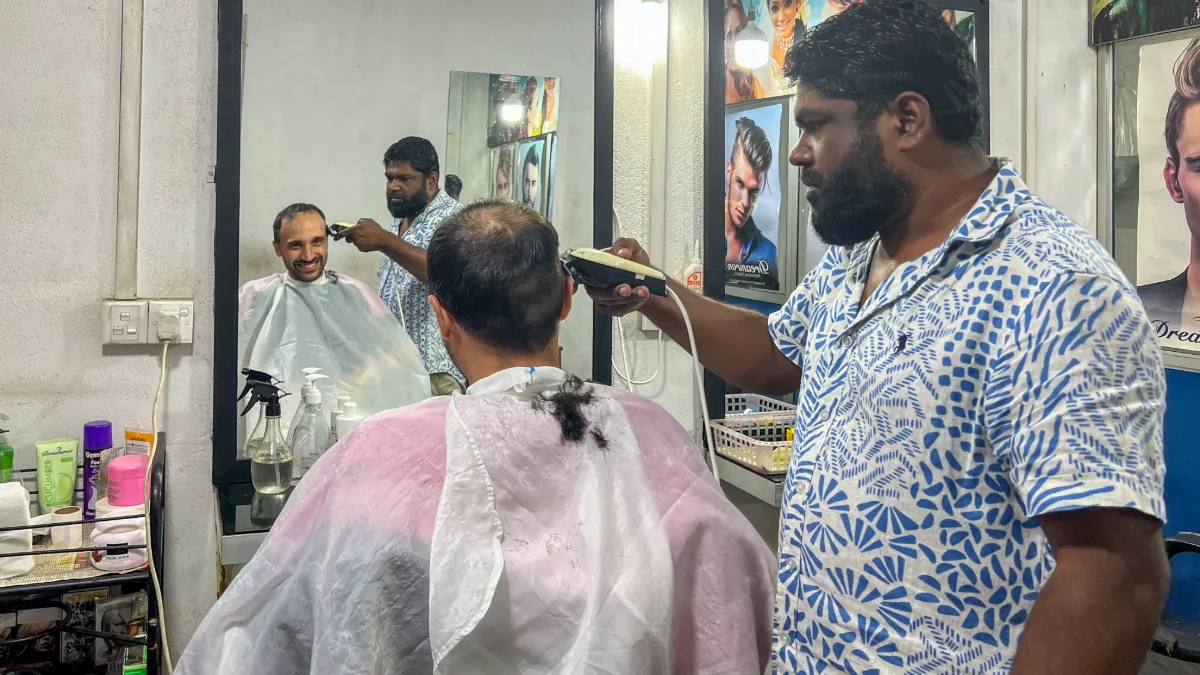Toti getting hair cut in Ella 1 Sri Lanka barber shop for Toti with massage from Bobby